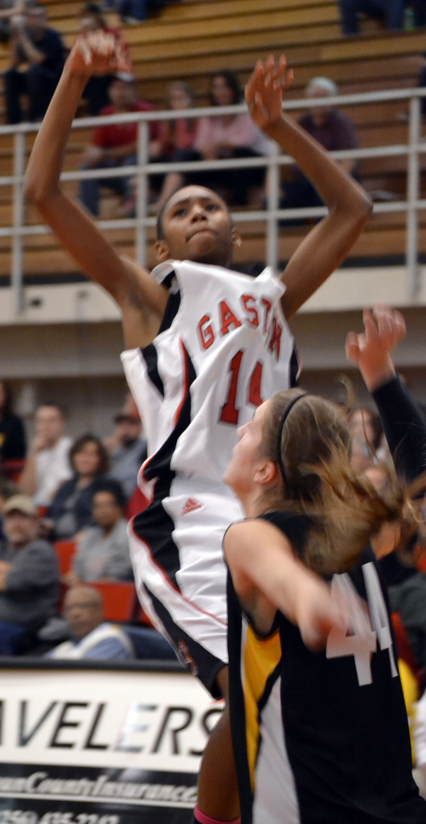 Photo: Gaston forward Felicia Porter (14) shoots over Woodville's Emily Huston in Class 1A Northeast Regional basketball action on Feb. 21. Porter was influential in the Lady Dawgs' win, scoring 11 points while pulling 17 rebounds. Photo by Joshua Price/Messenger.