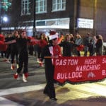 Members of the Gaston High School Marching Bulldog Band carry a banner and march in the City of Gadsden Christmas parade.