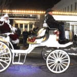 Santa Claus waves to the crowd from a horse-drawn carriage during the City of Gadsden Christmas parade on December 15 on Broad Street.