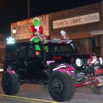 The Grinch rides atop a Jeep and poses for the crowd during the Attalla Christmas parade.