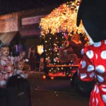 Children wave to Minnie Mouse as Mrs. Claus greets the crowd in the background during the Attalla Christmas parade.