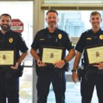 City of Gadsden Police Officers pose for a photo with awards presented to them by Gadsden Mayor Craig Ford on December 6 at City Hall. From left, Officer Chris Philllips, Sergeant Danny Haas and Officer Alec Burgess.