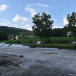 Members of the skating community pitch in their own time and money to fix up a cement slab for the skate community.