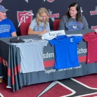 Gracey Lanford signing her golf scholarship with her parents.
Submitted photo